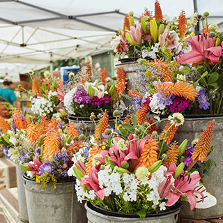 Bouquets of fresh cut flowers on display at a farmers market.
