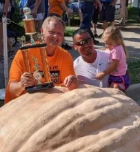 Don Young and his son-in-law Tommy Rhodes with winning pumpkin.