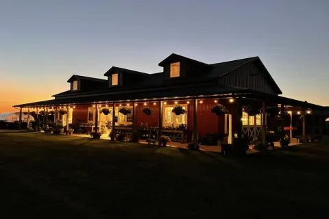 Harvestville Farm lit up as the sun is almost set.