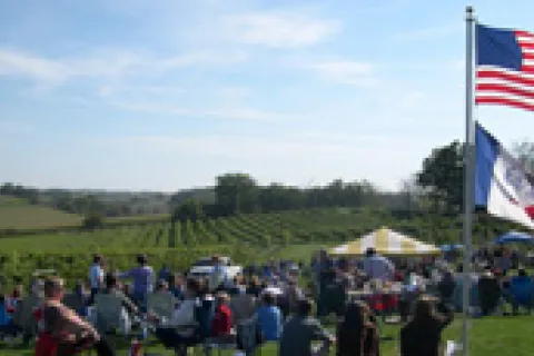 Visitors in front of lush green field.