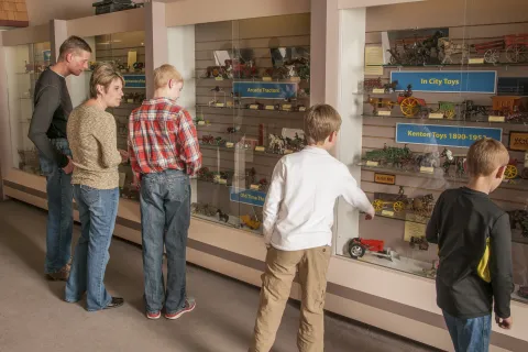 Family exploring the items in the National Farm Toy Museum.