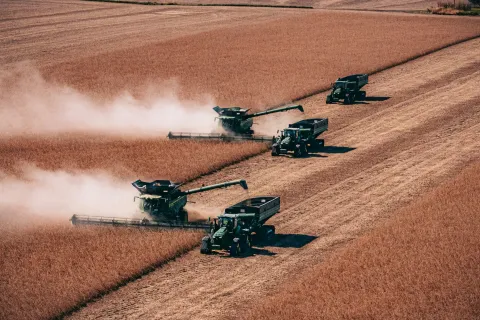 Two combines harvesting soybeans during fall harvest in Iowa.